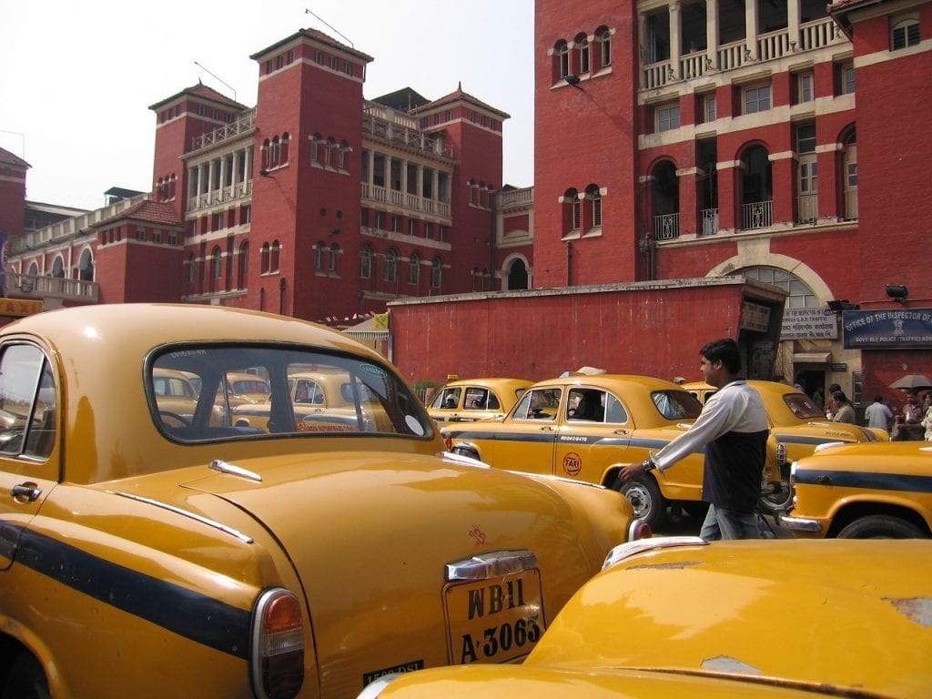 The famous Ambassador taxis waiting outside a train station in Culcatta, India