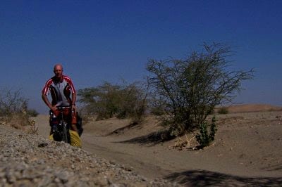 Dave Briggs cycling in the Sudan desert near the Nile
