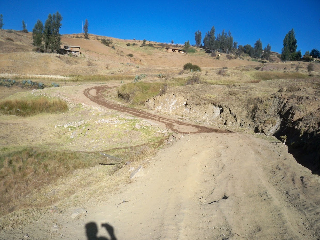 Cycling along the rough road leading out of Angasmarca in Peru