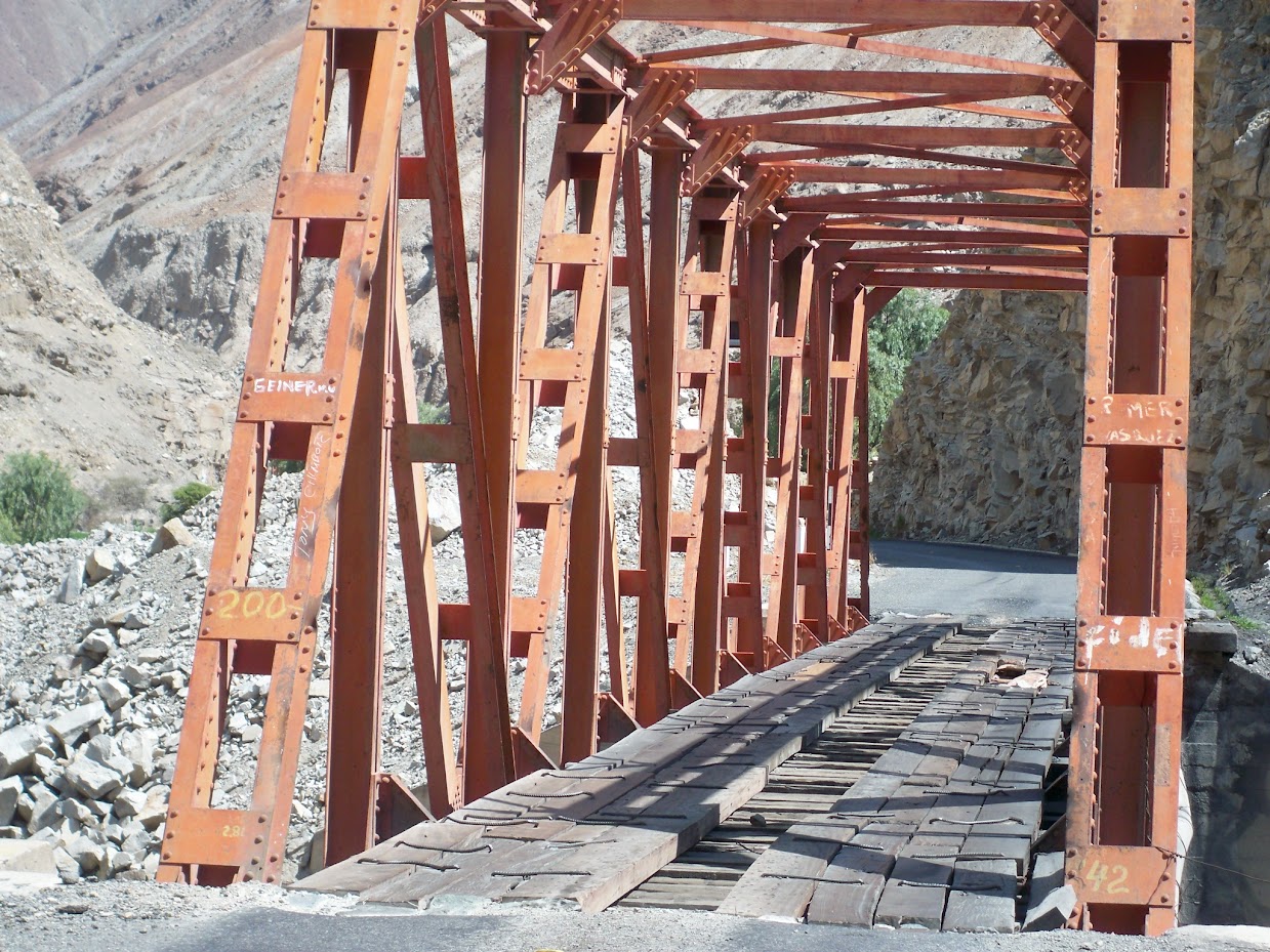 Crossing a bridge by bicycle in peru