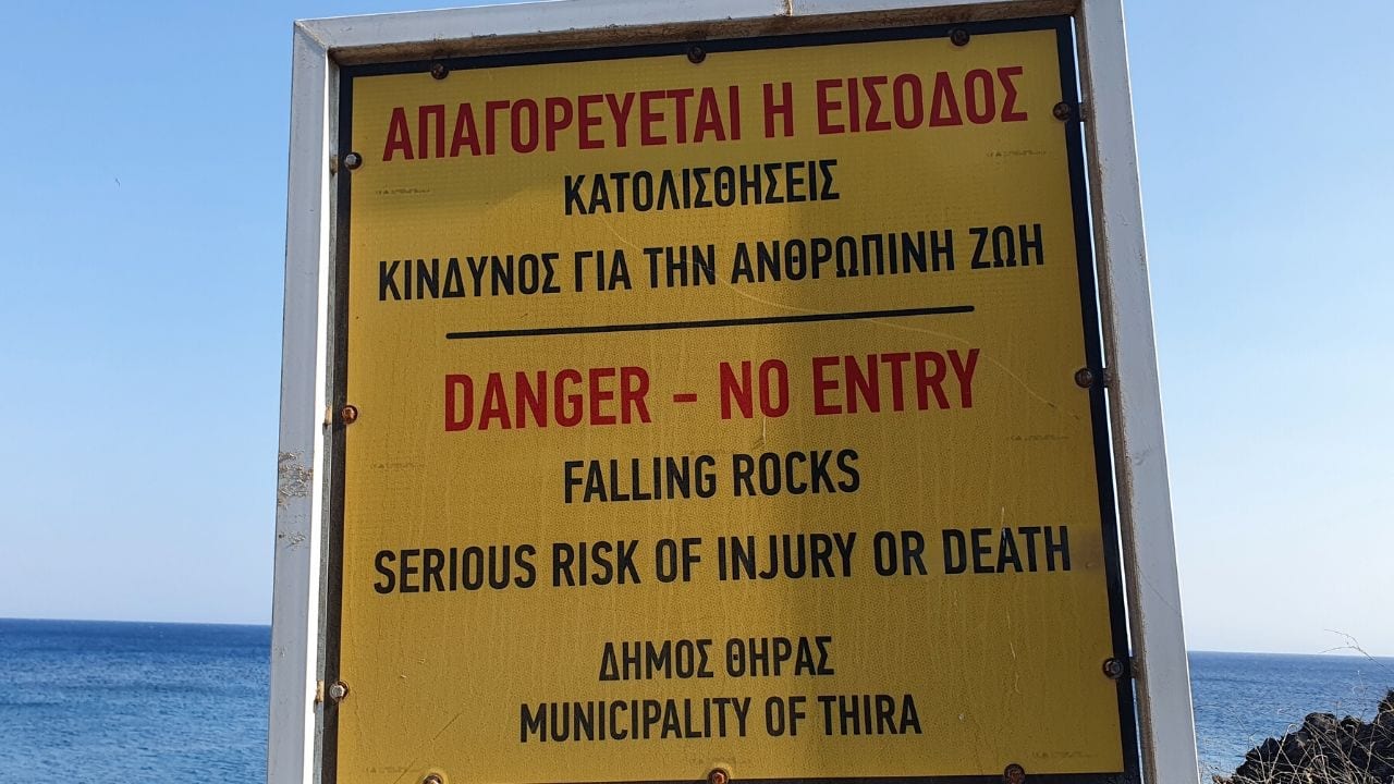 Danger of rockslides at Red Beach in Santorini Greece
