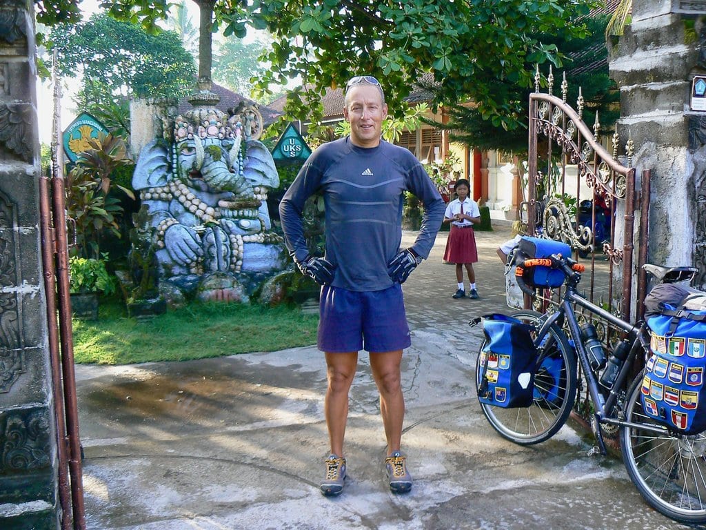 Efren with his bicycle outside a school