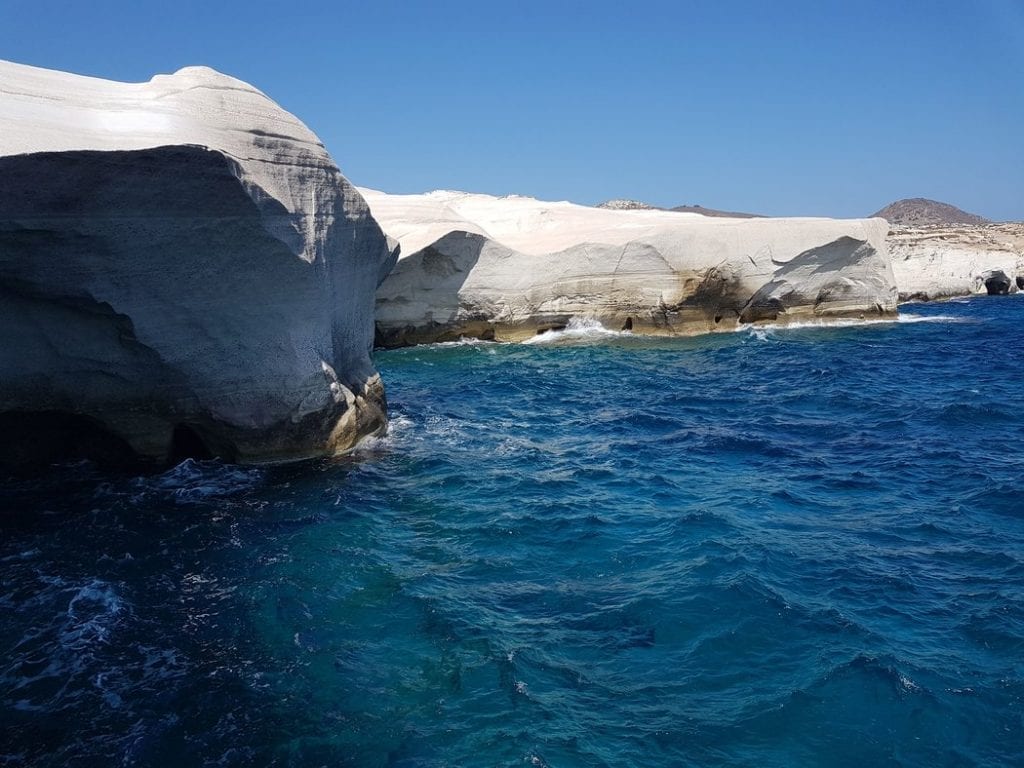 The beautiful white beach of Milos contrasted against the stunning blue of the Greek sea.