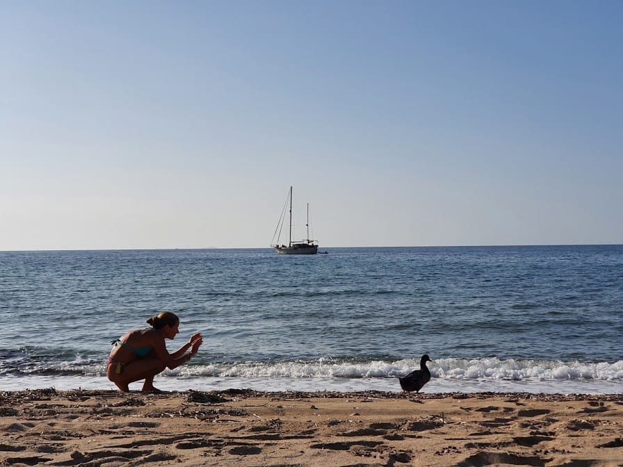 Vanessa and a duck on Agios Ioannis beach Milos
