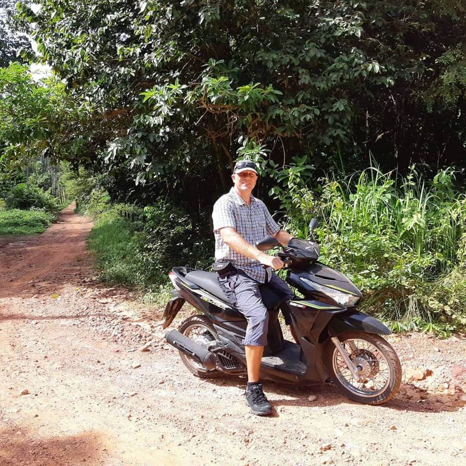 Dave on a moped in Thailand