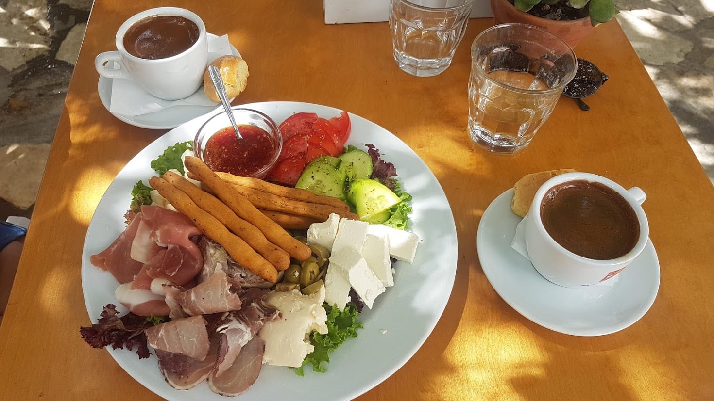 Traditional Greek coffee and a meze of food