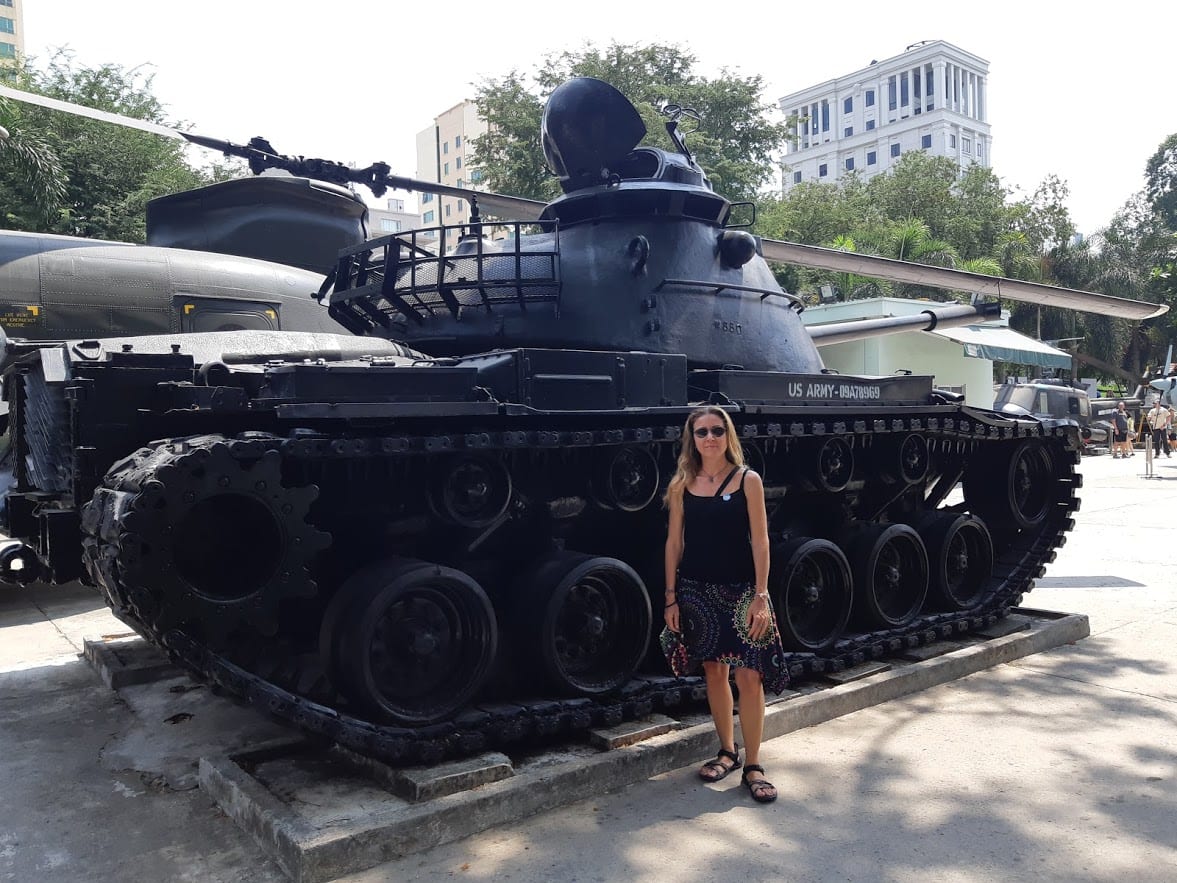 Vanessa in front of a tank in Saigon