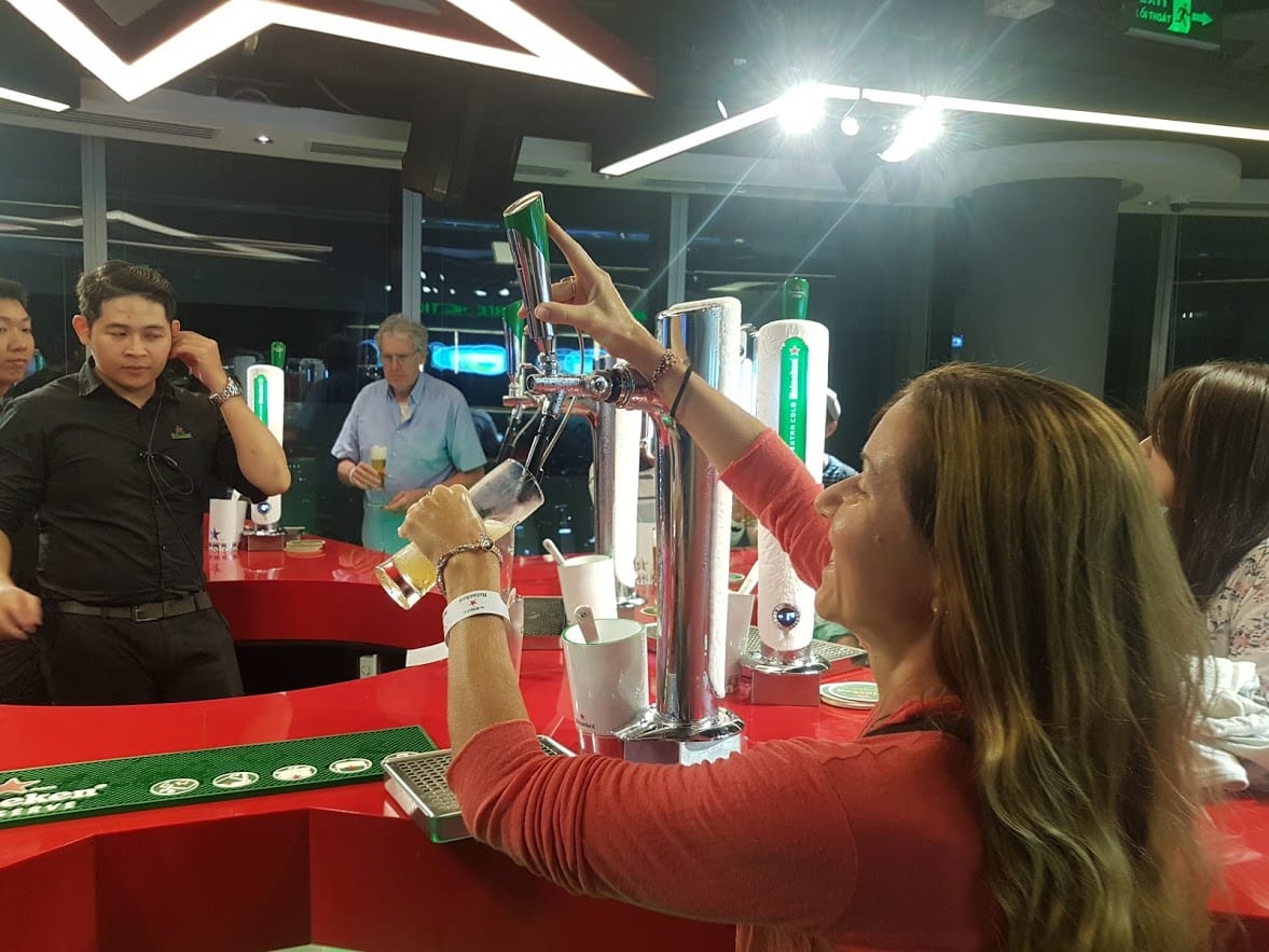 Vanessa pouring a pint in the Heineken Bar in Saigon
