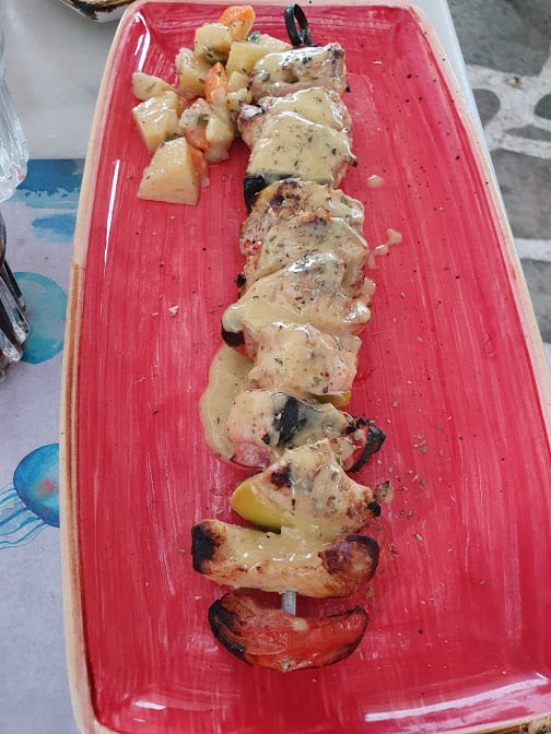 Eating a swordfish souvlaki in Medusa in Milos island Greece
