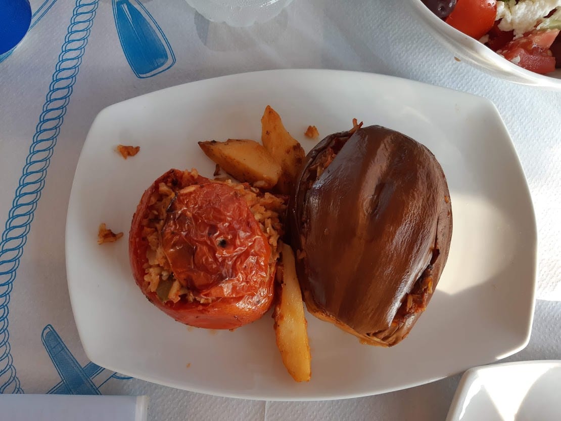 Eating stuffed tomatoes in the taverna on Kalamitsi Beach in Kimolos