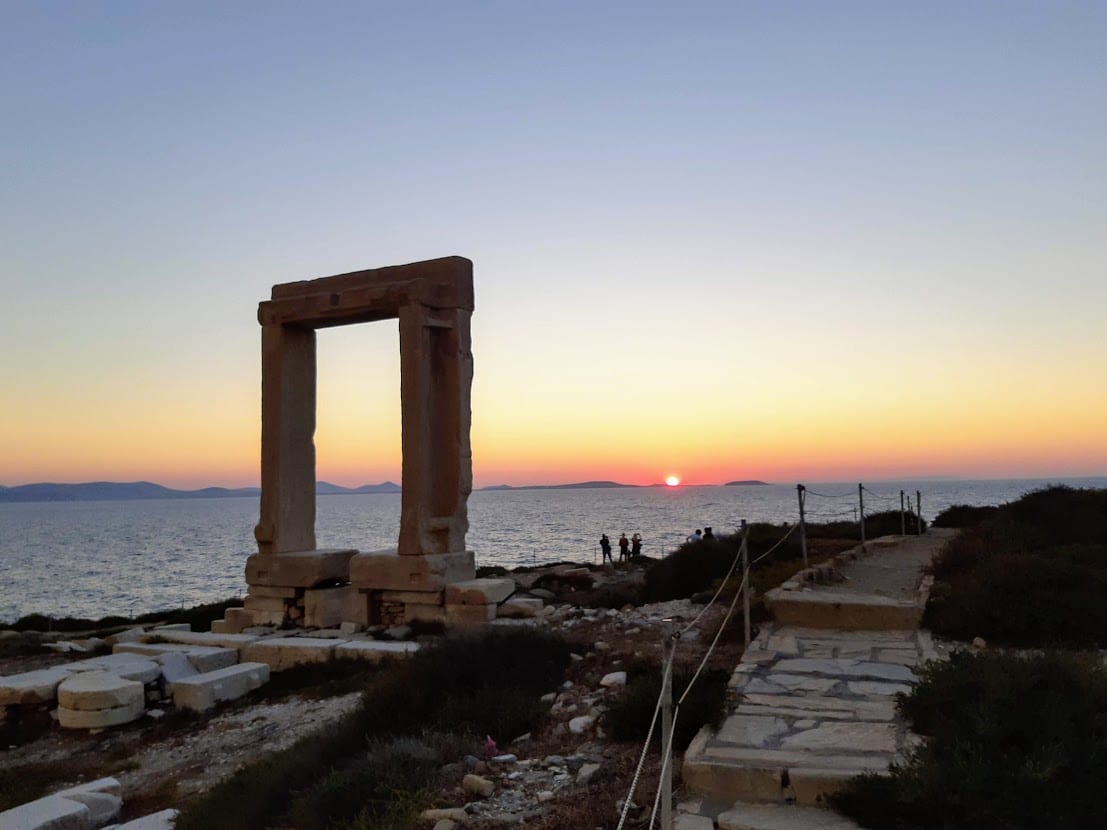 Enjoying the sunset at the Portara in Naxos island Greece