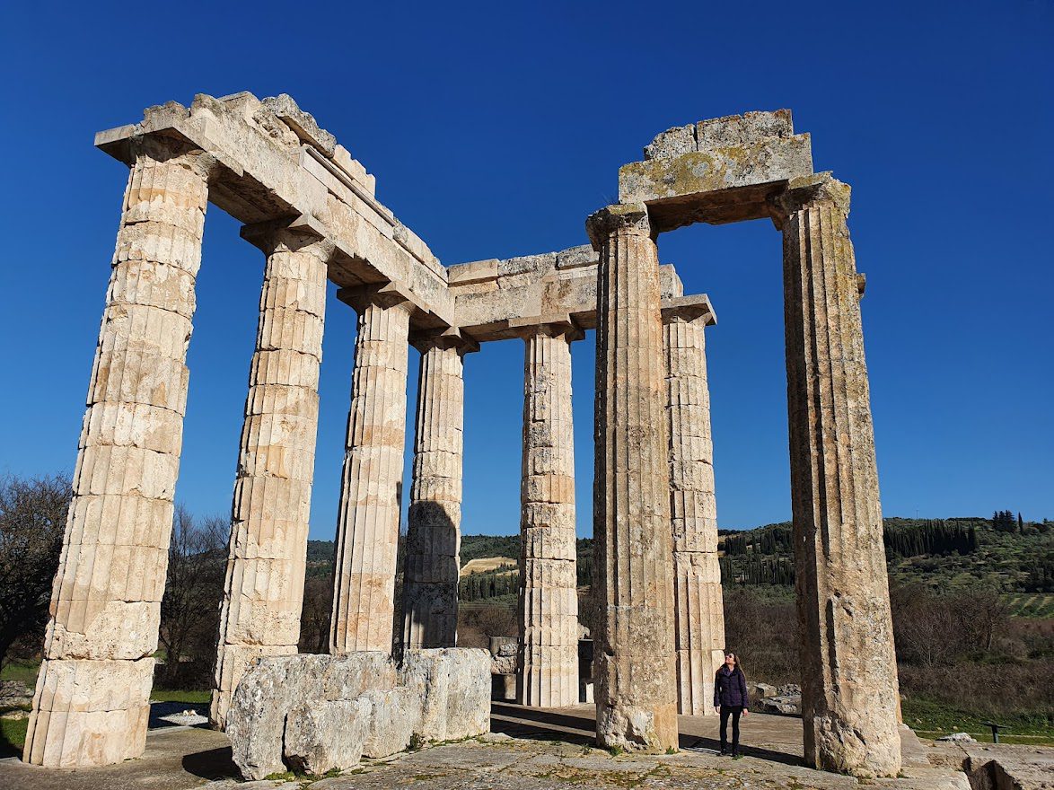 A person standing at the temple at Nemea to give an idea of scale