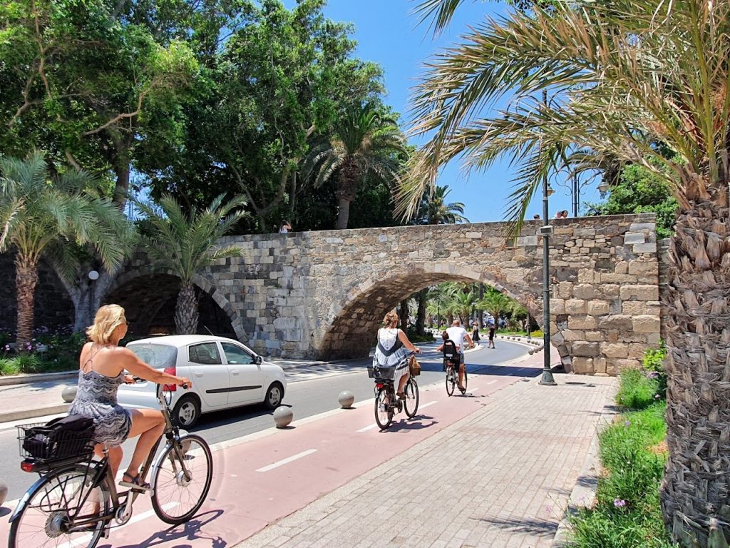 people cycling on the bike lanes in kos town, in greece
